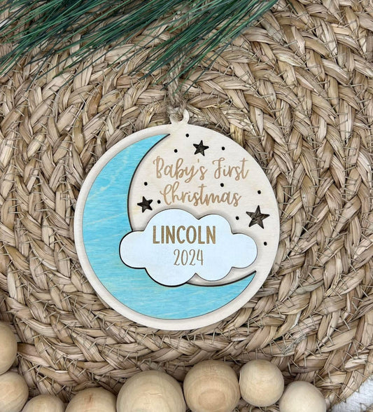 Decorative ornament for 'Baby's First Christmas' with name 'Lincoln' and year '2024' on a woven surface.