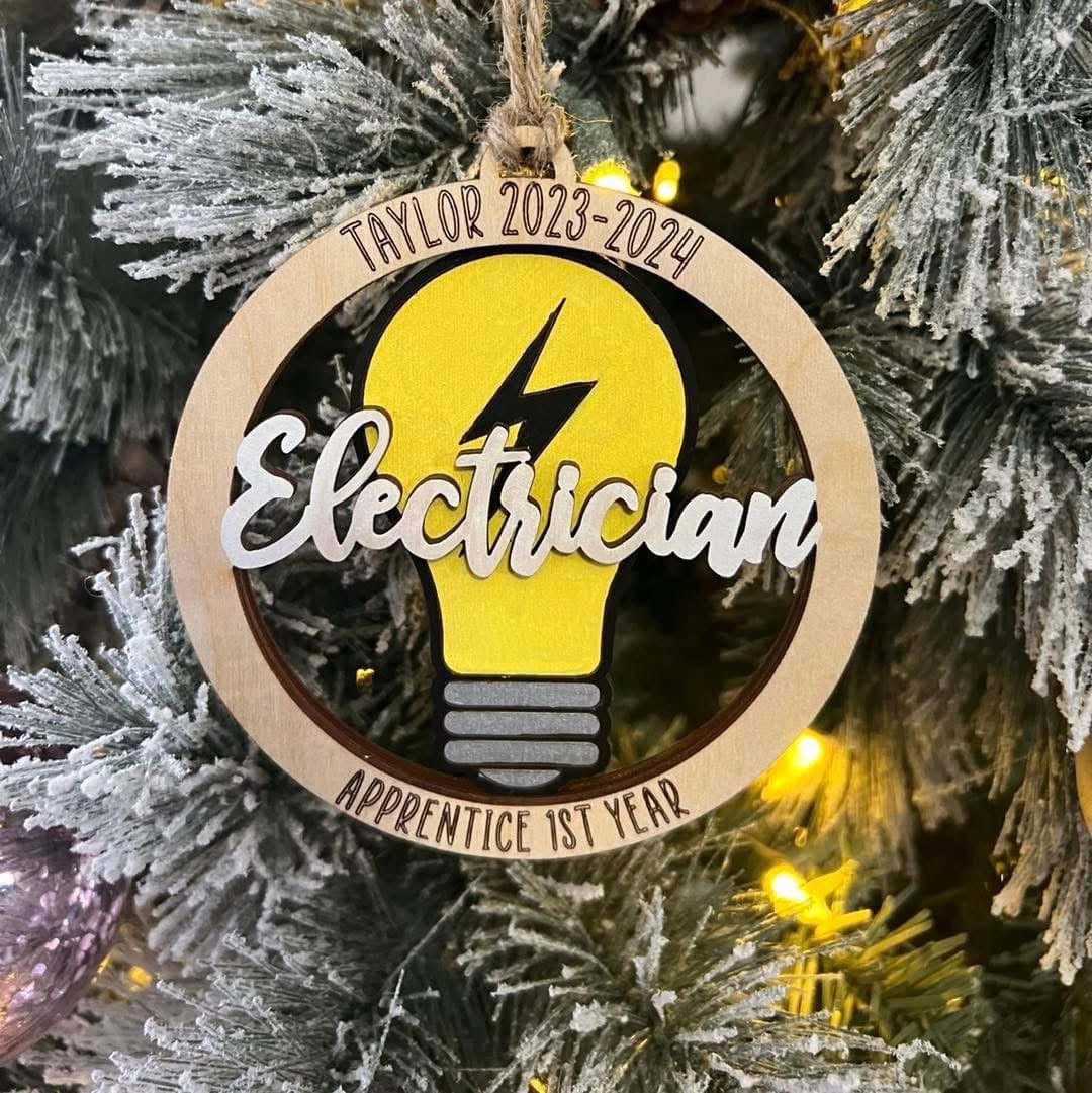 Decorative ornament with electrician design on a Christmas tree.