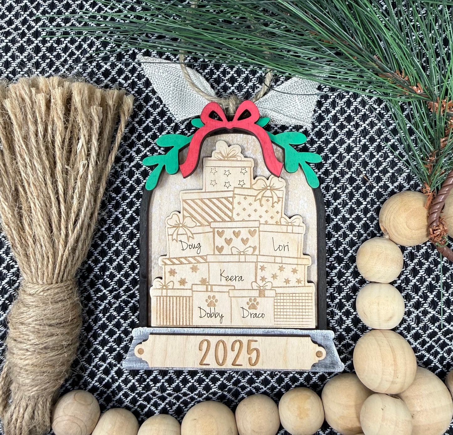 Decorative wooden ornament with '2025' on a textured fabric background with decorative elements.